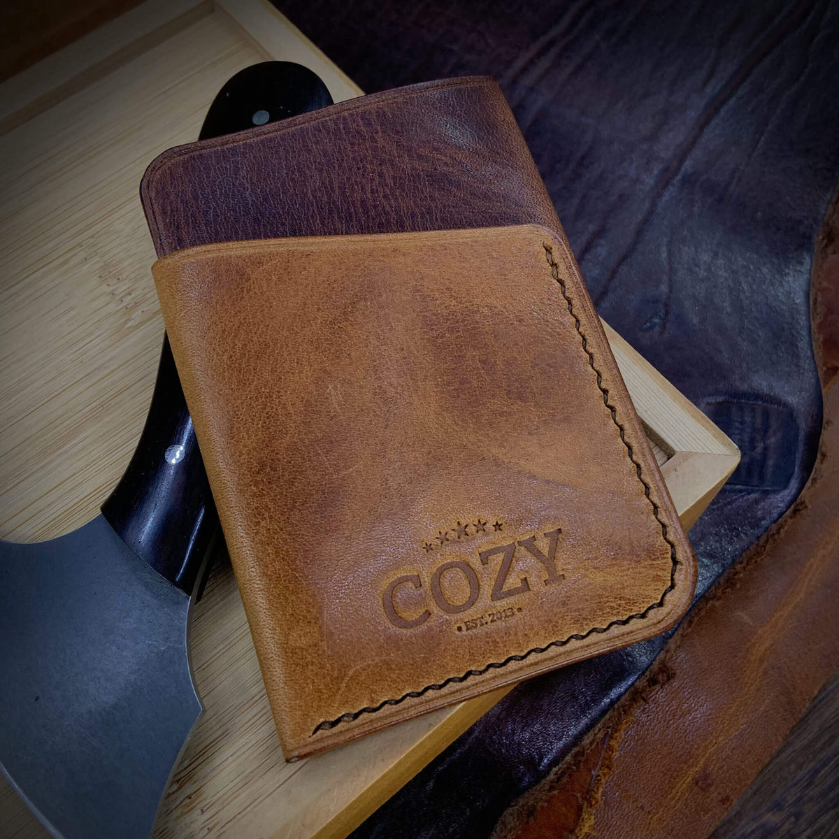 COZY Slim Sleeve Wallet in two-tone dark and tan brown full grain leather, showing COZY stamp and saddle stitching detail