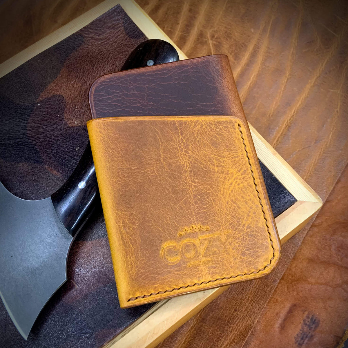 COZY Slim Sleeve Wallet in two-tone wax cognac and napoli full grain leather, showing COZY stamp and saddle stitching detail