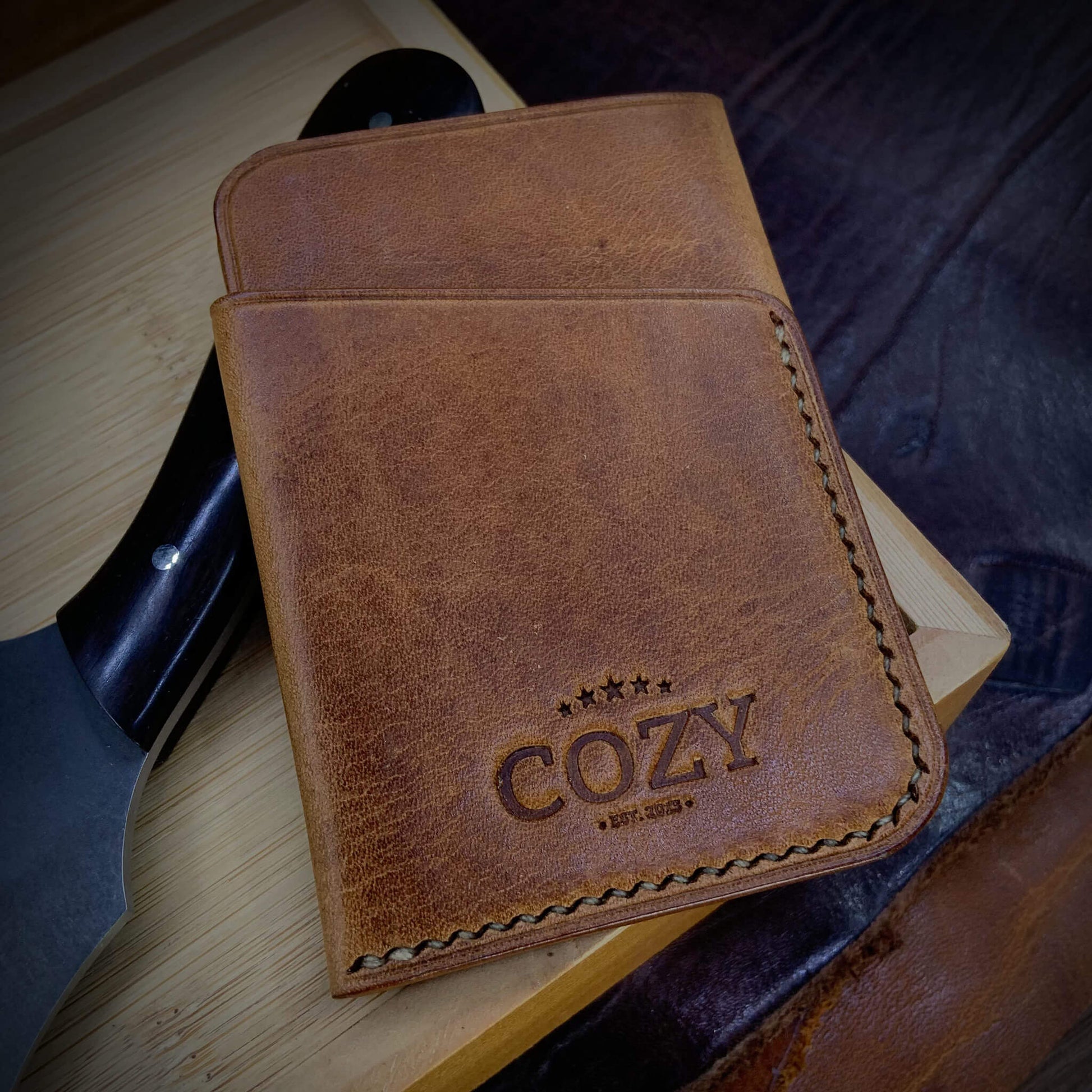 COZY Slim Sleeve Wallet in tan brown full grain leather, showing COZY stamp and saddle stitching detail