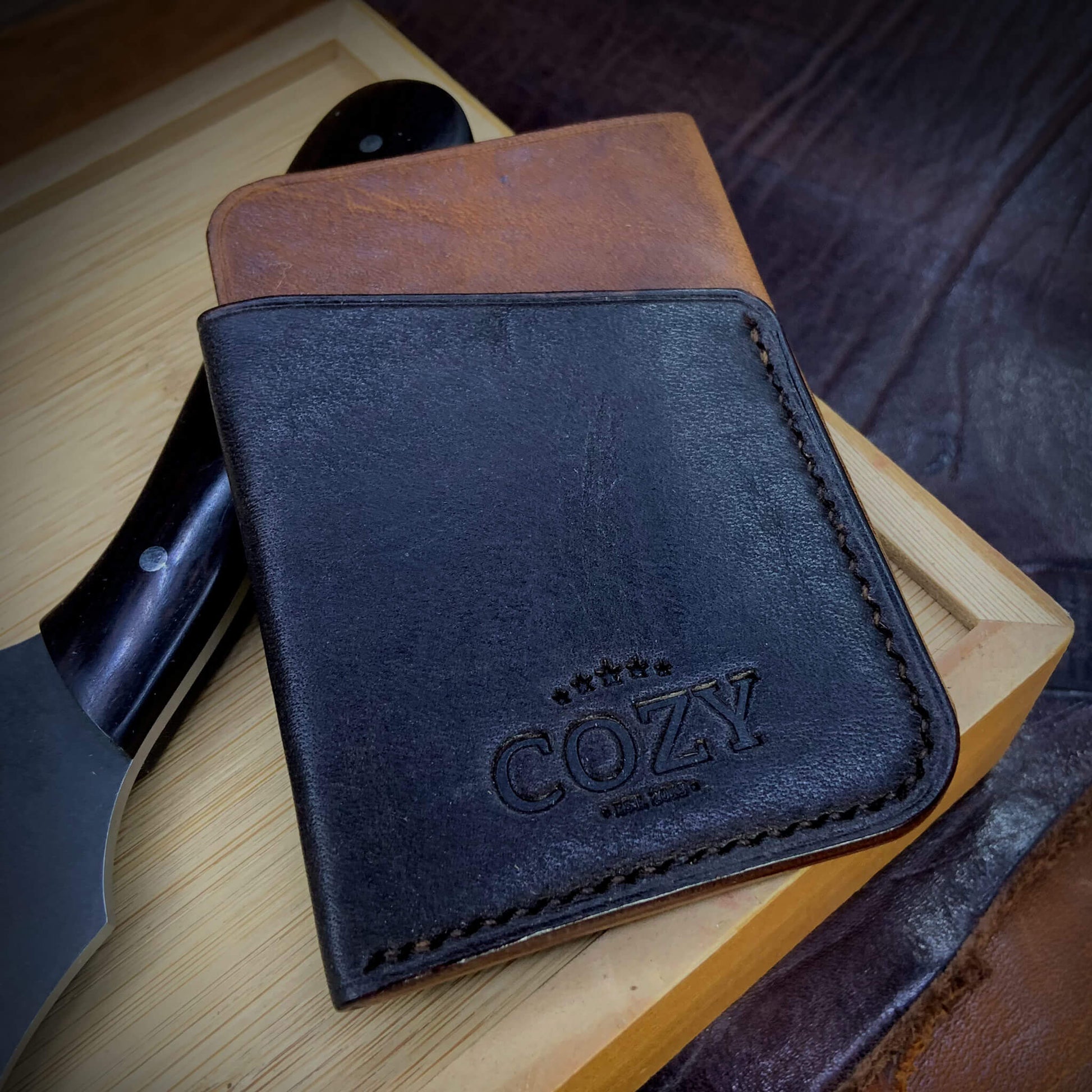 COZY Slim Sleeve Wallet in two-tone brown and dark brown full grain leather, showing COZY stamp and saddle stitching detail