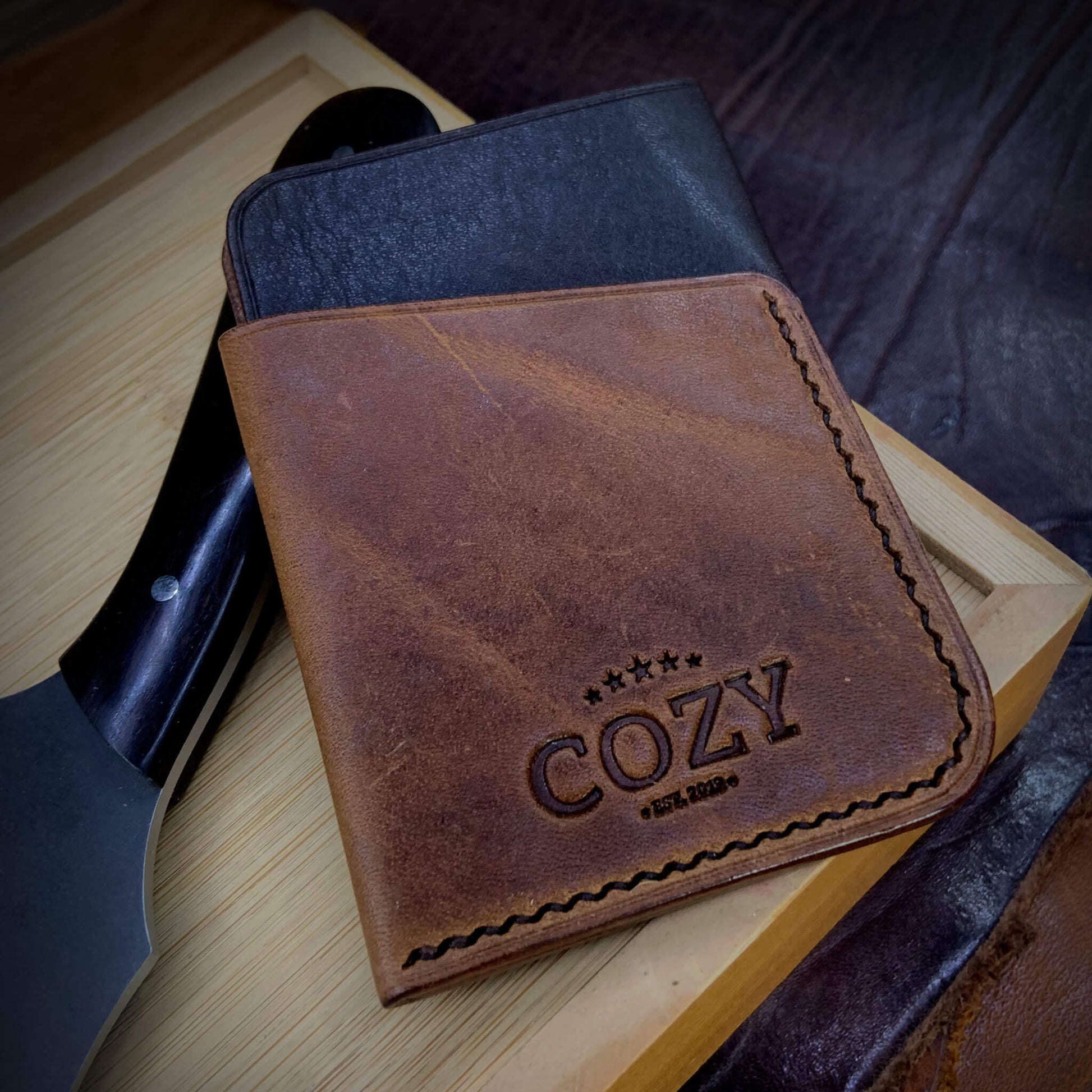 COZY Slim Sleeve Wallet in two-tone dark brown and brown full grain leather, showing COZY stamp and saddle stitching detail