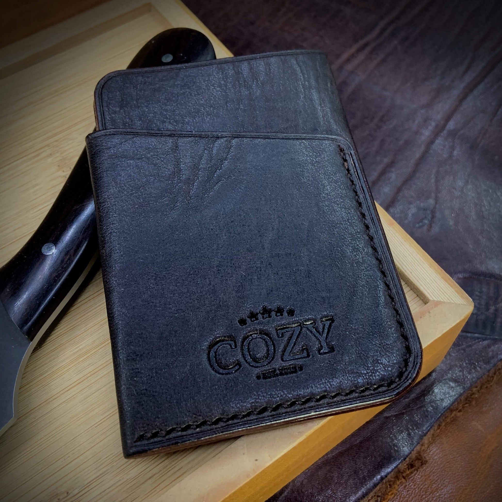 COZY Slim Sleeve Wallet in deep dark brown full grain leather, showing natural grain texture, COZY stamp and hand saddle stitching
