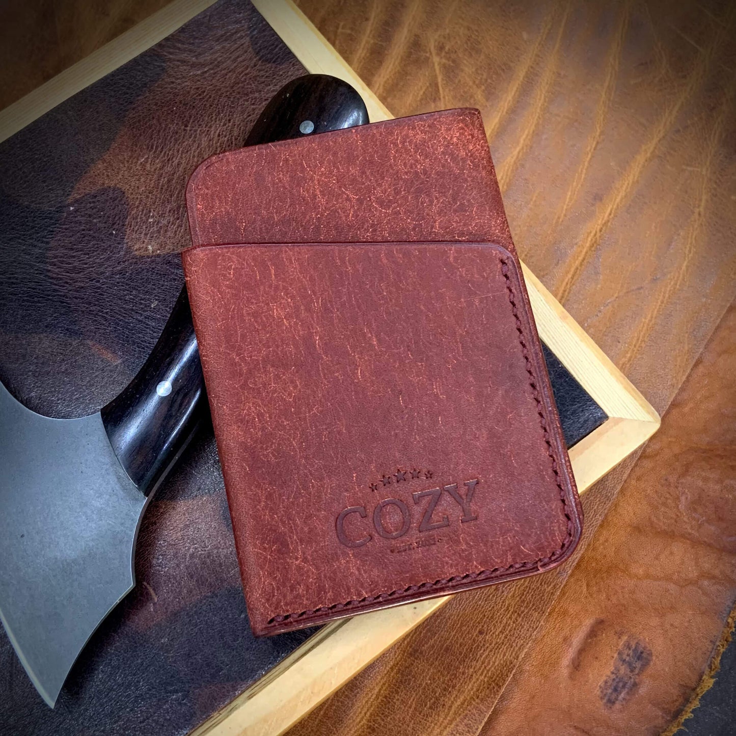 COZY Slim Sleeve Wallet in pueblo cocinella full grain leather, showing COZY stamp and saddle stitching detail
