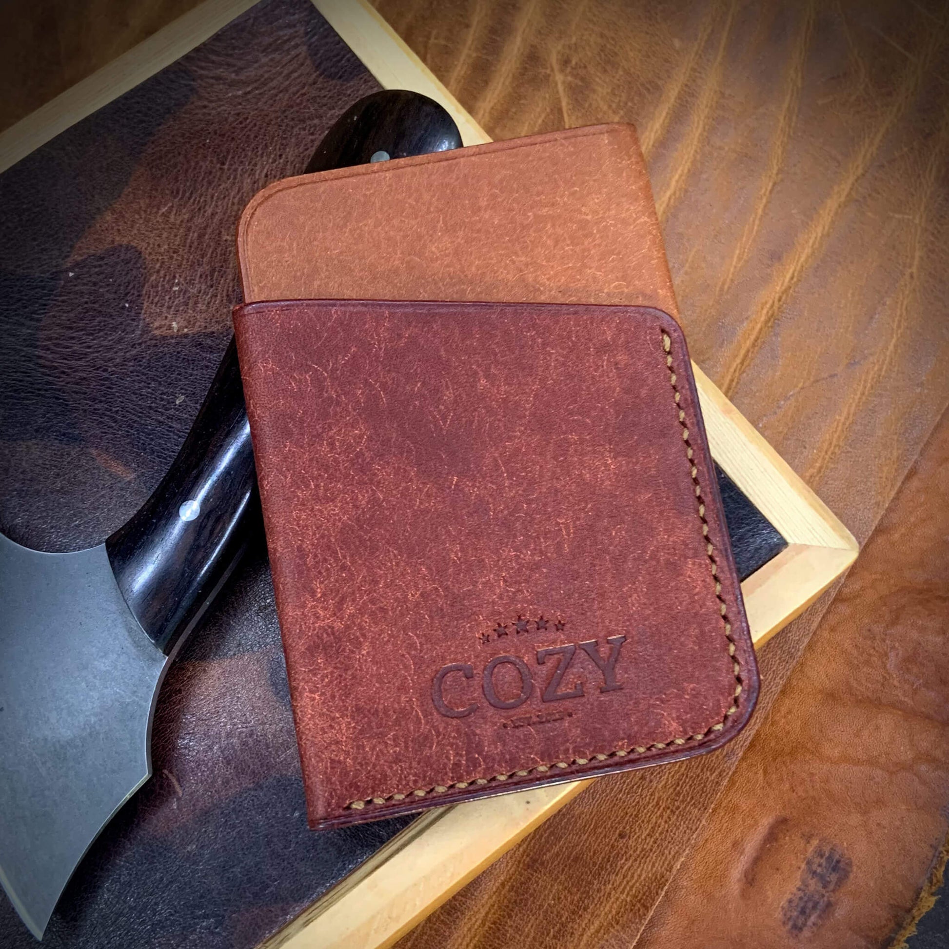 COZY Slim Sleeve Wallet in two-tone pueblo russet and cocinella full grain leather, showing COZY stamp and saddle stitching detail