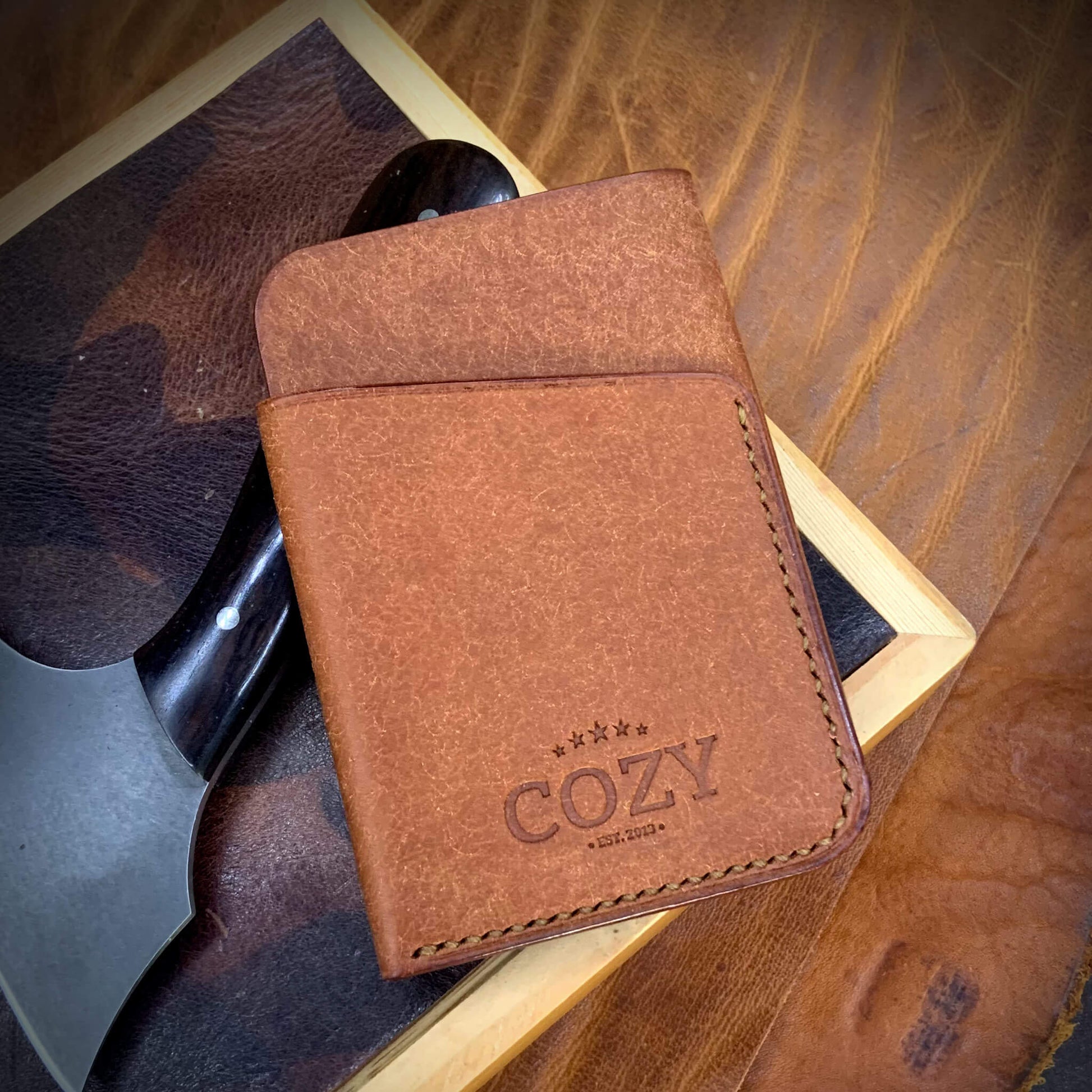 COZY Slim Sleeve Wallet in pueblo russet full grain leather, showing COZY stamp and saddle stitching detail