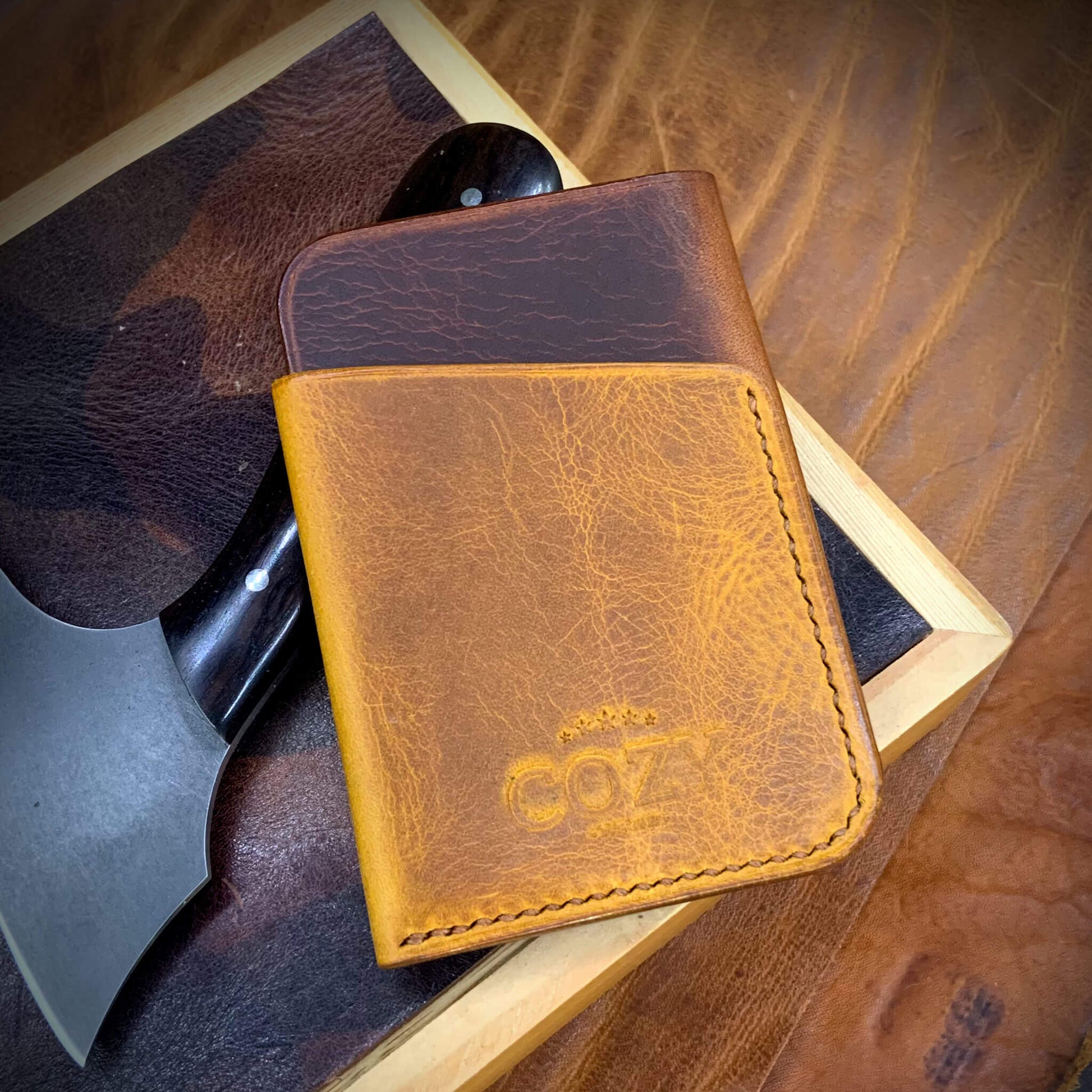 COZY Slim Sleeve Wallet in two-tone wax cognac and napoli full grain leather, showing COZY stamp and saddle stitching detail