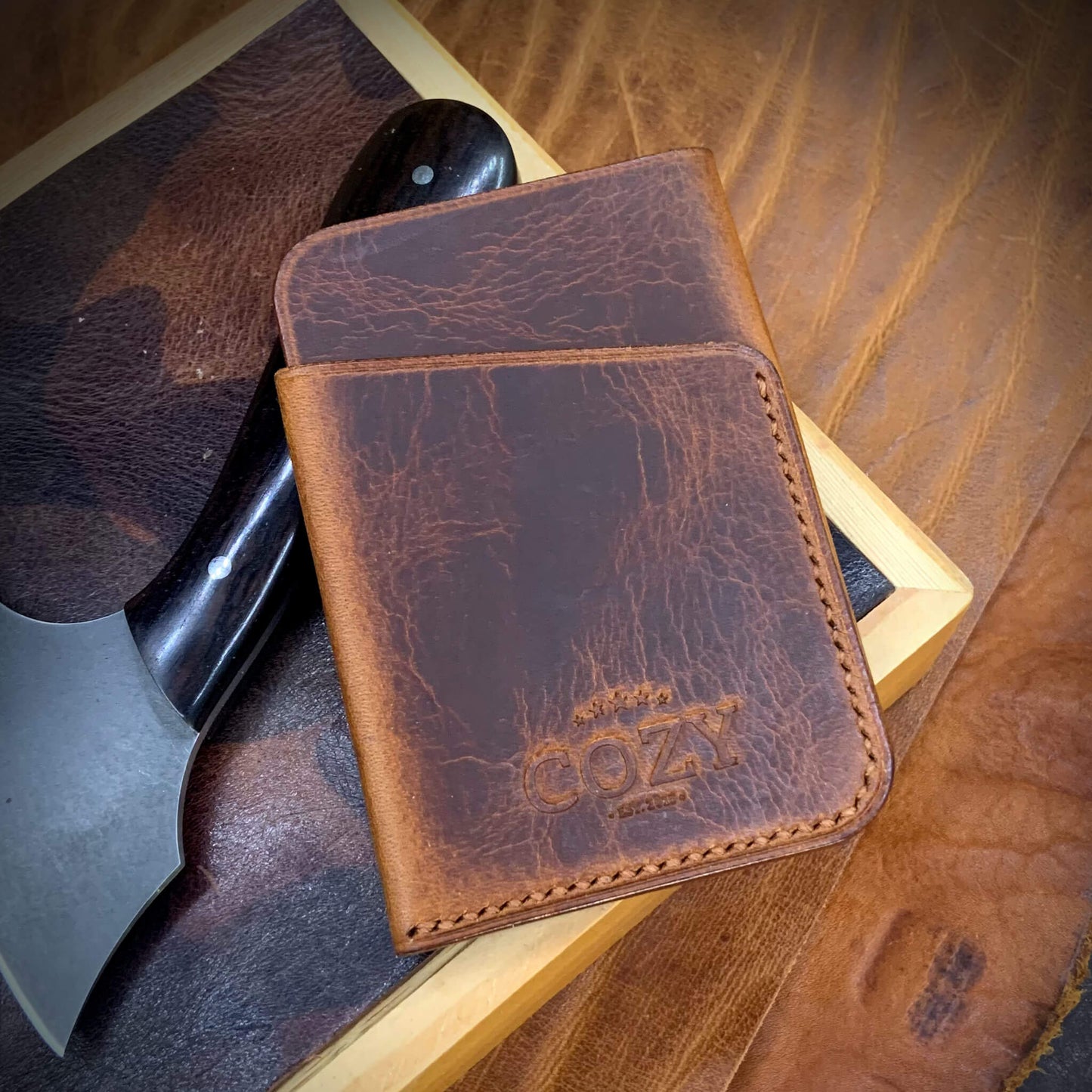 COZY Slim Sleeve Wallet in wax cognac full grain leather, showing COZY stamp and saddle stitching detail