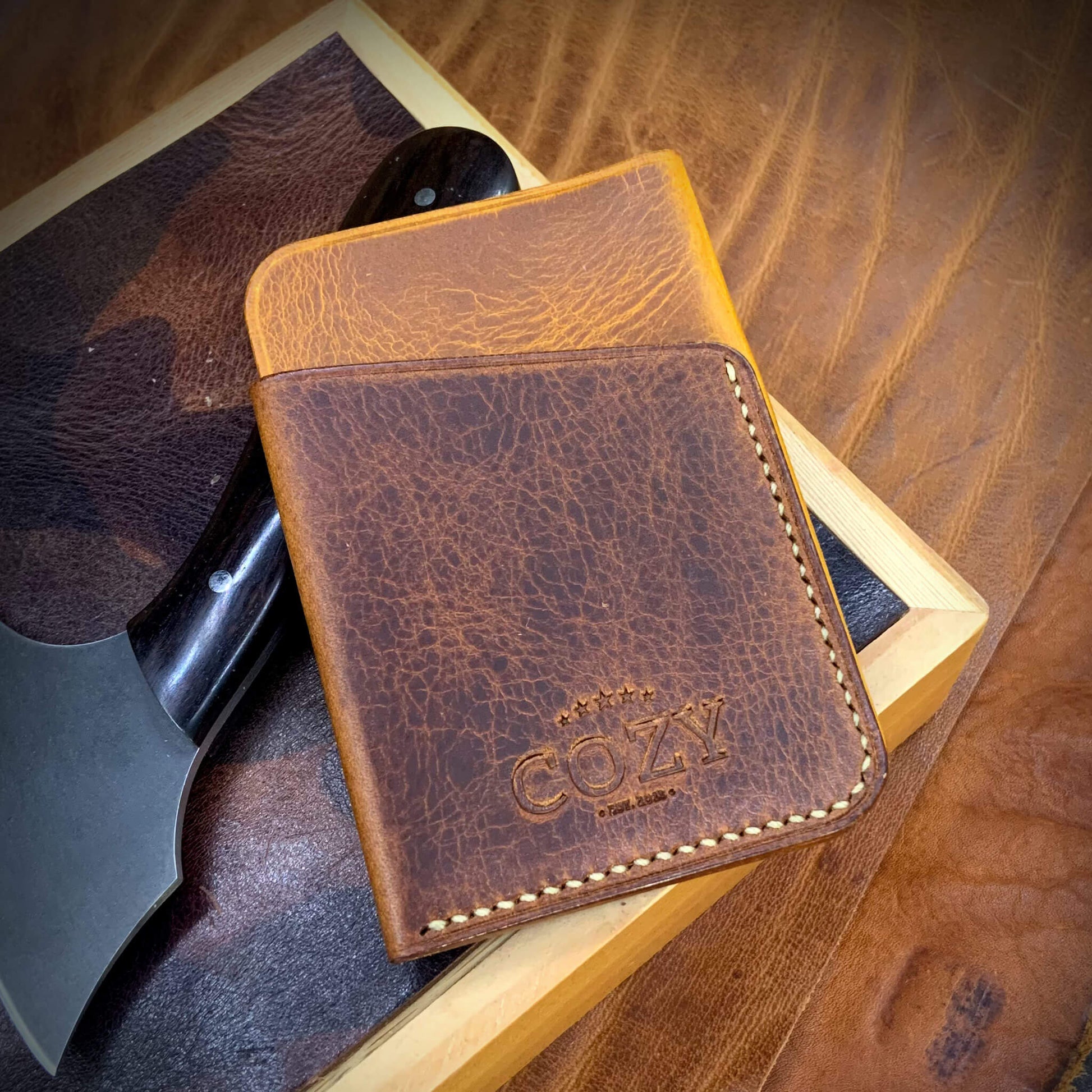 COZY Slim Sleeve Wallet in two-tone wax napoli and gognac full grain leather, showing COZY stamp and saddle stitching detail