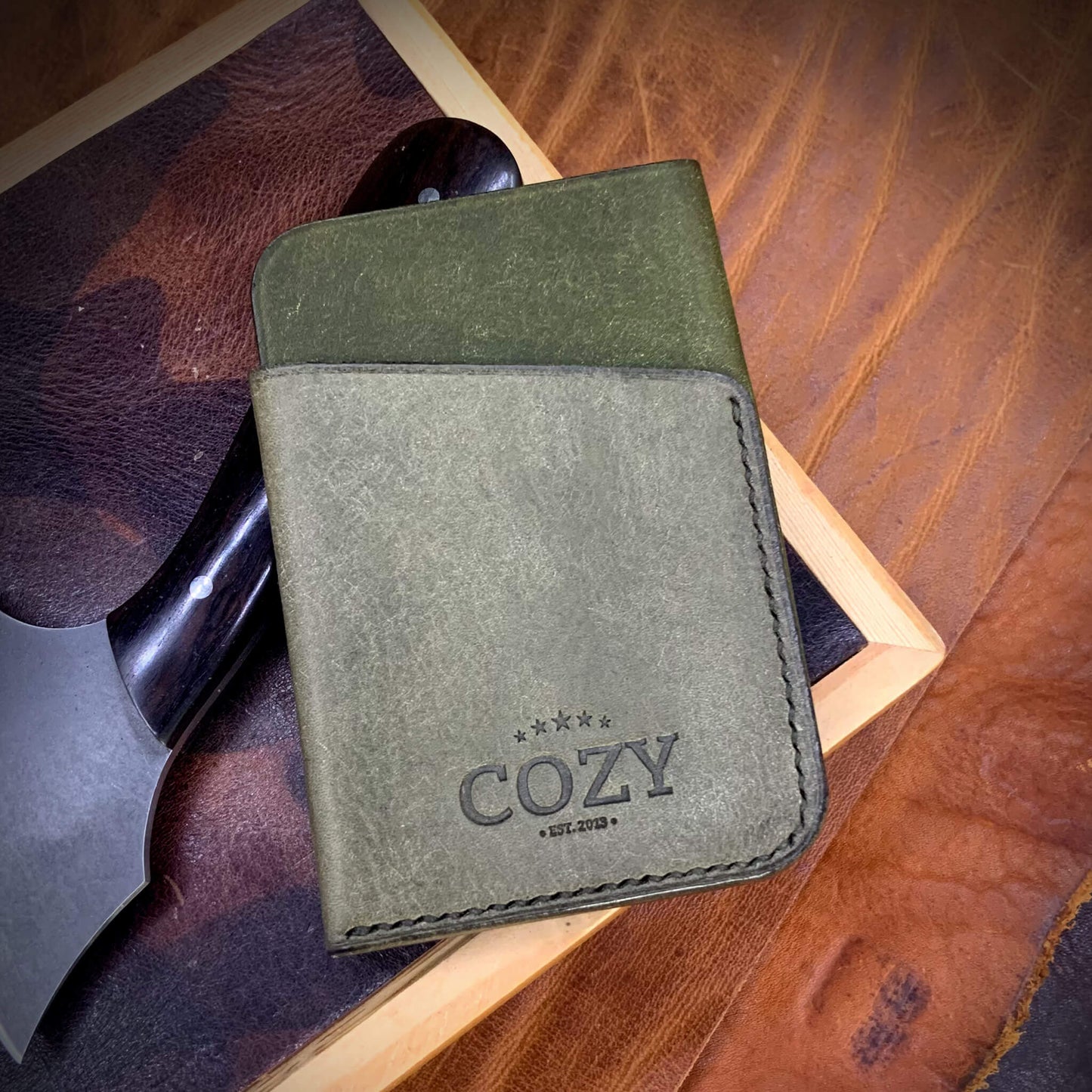 COZY Slim Sleeve Wallet in two-tone pueblo oliva and rustic olive full grain leather, showing COZY stamp and saddle stitching detail