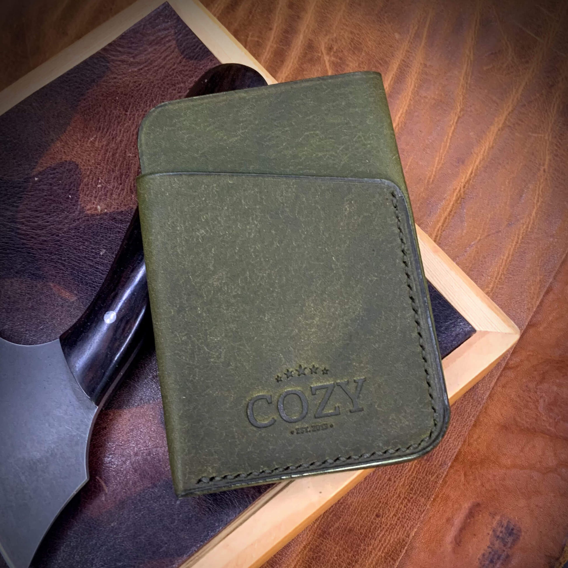 COZY Slim Sleeve Wallet in pueblo oliva full grain leather, showing COZY stamp and saddle stitching detail