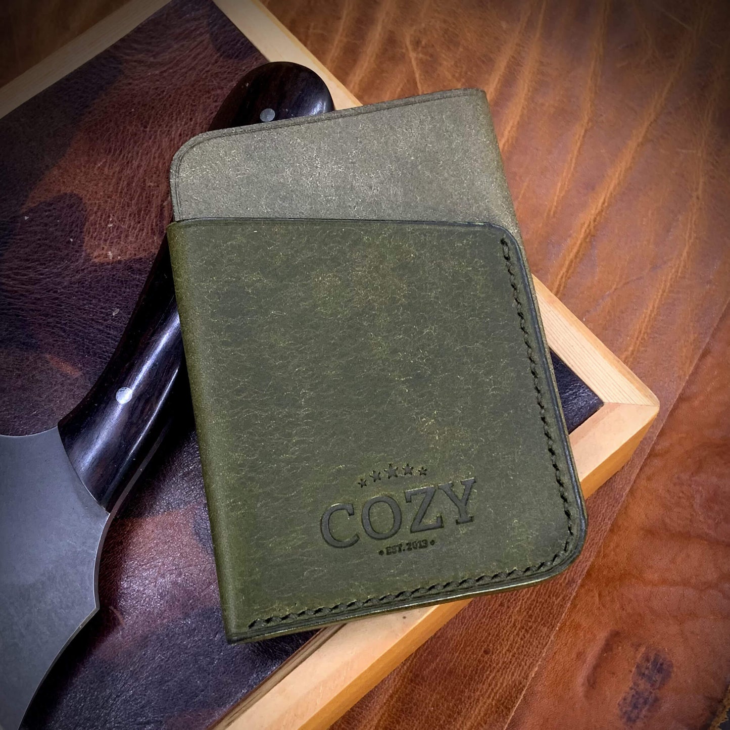 COZY Slim Sleeve Wallet in two-tone pueblo rustic olive and oliva full grain leather, showing COZY stamp and saddle stitching detail