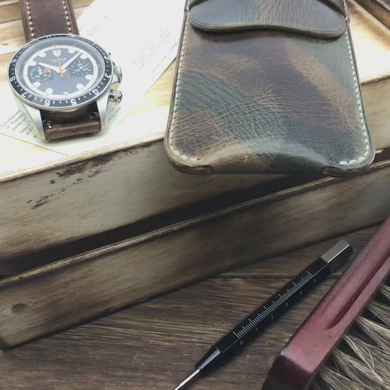 Video demonstration showing a luxury watch sliding smoothly into a lined, tan leather travel watch pouch by Cozy Handmade.