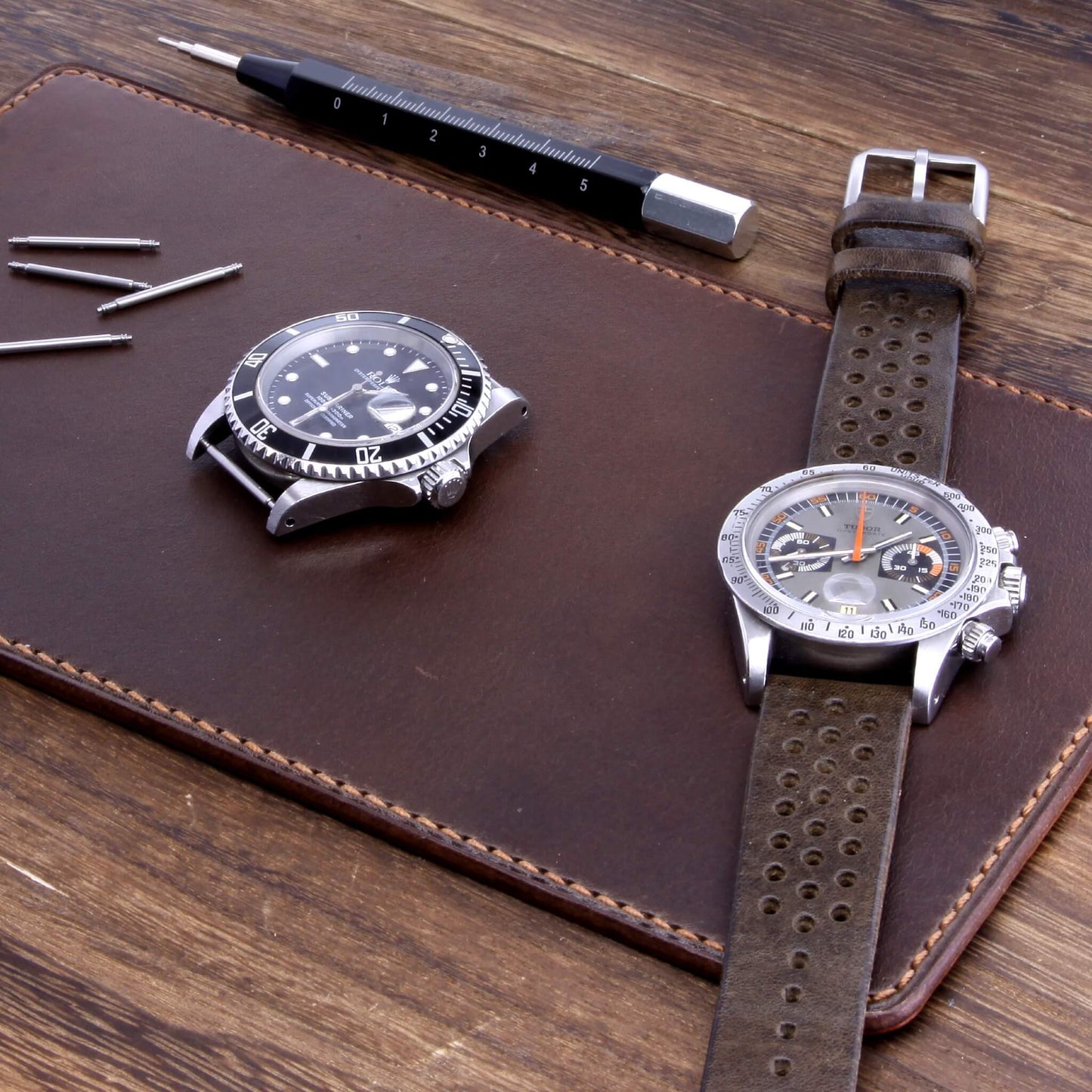 Handcrafted Leather Watch Valet in Sequoia 106 (dark reddish brown) Italian vegetable-tanned leather with luxury watches and strap resting on it — Cozy Handmade