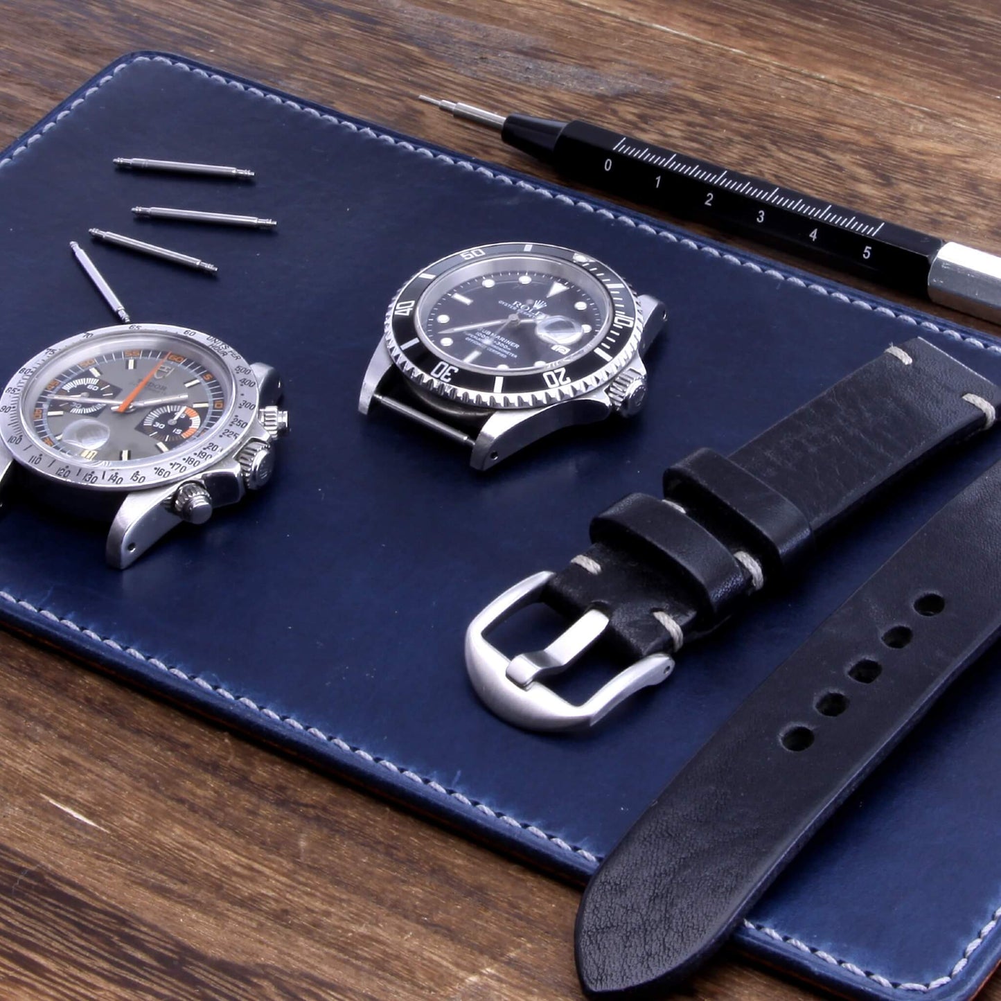 Handcrafted Leather Watch Valet in Sequoia 108 (navy blue) Italian vegetable-tanned leather with luxury watches and strap resting on it — Cozy Handmade